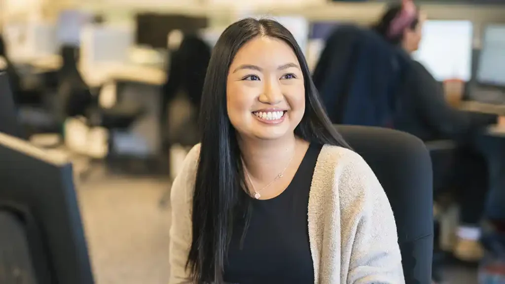 Administrative assistant smiling at desk